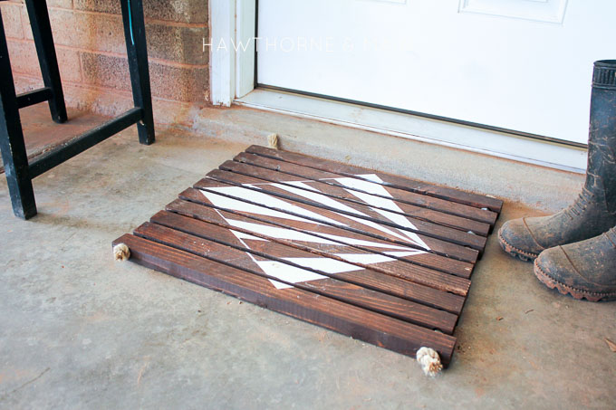 Check out this simple wood slat door mat! I love the geometric pattern that she added to it. This really would be so fun to make for our side entry to help with dirt! 