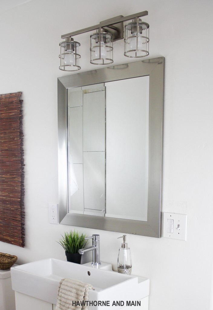 Simple bathroom update. I love that mirror and light. Such a great bathroom! 