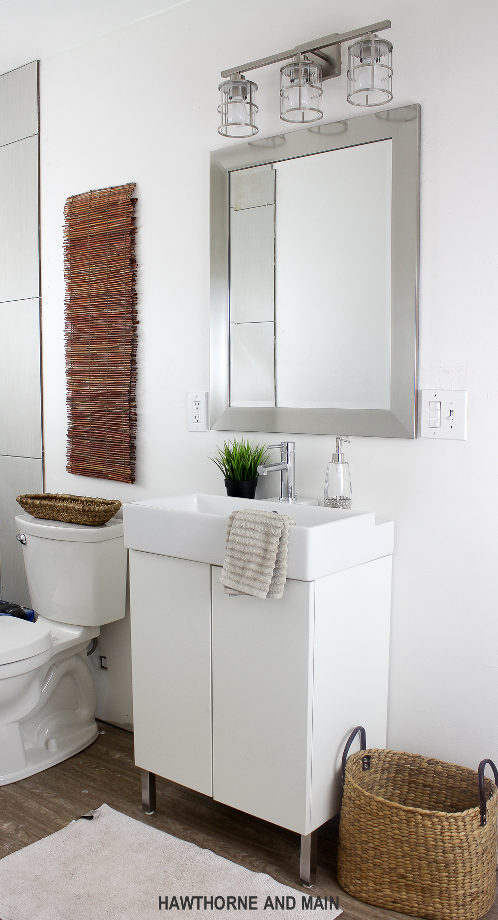 Simple bathroom update. I love that mirror and light. Such a great bathroom! 