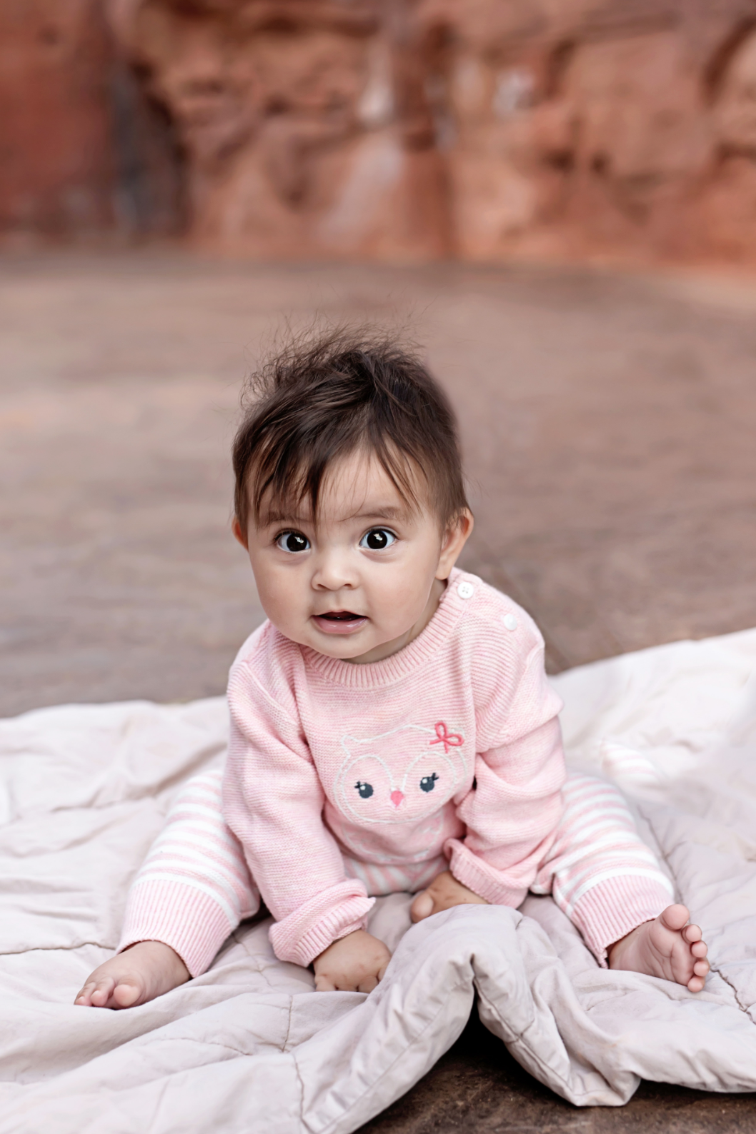 Premium Photo A Baby Sitting On A Blanket