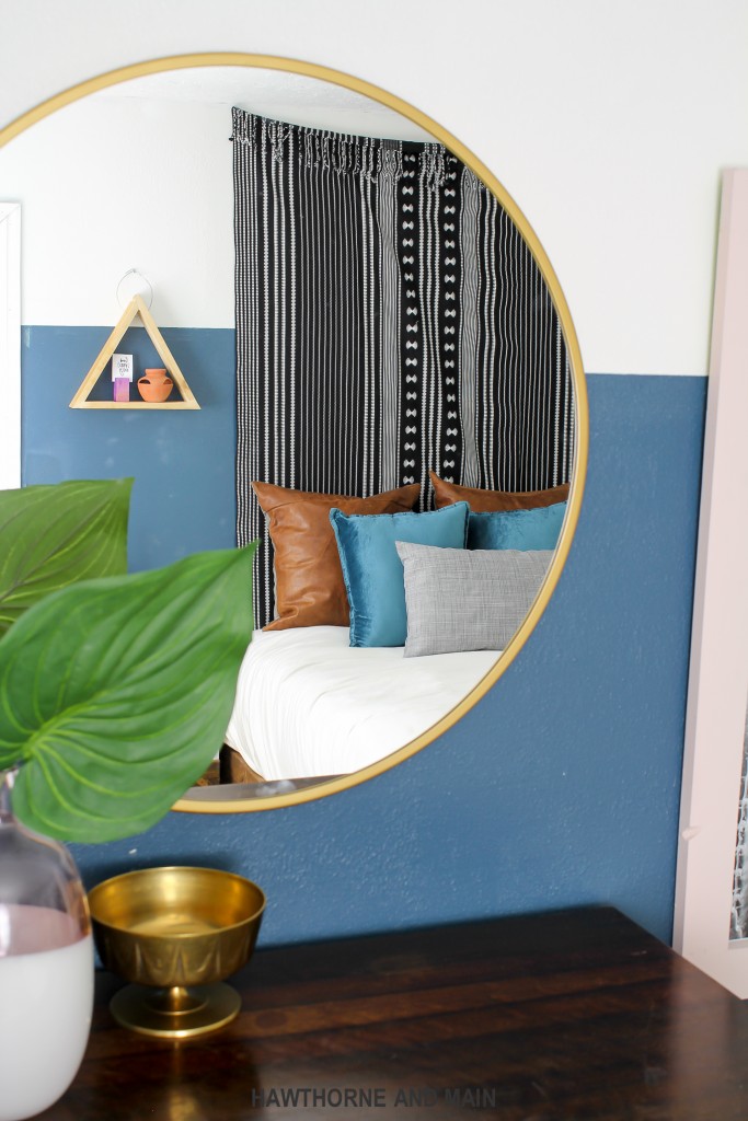 round-brass-mirror-in-a-bedroom